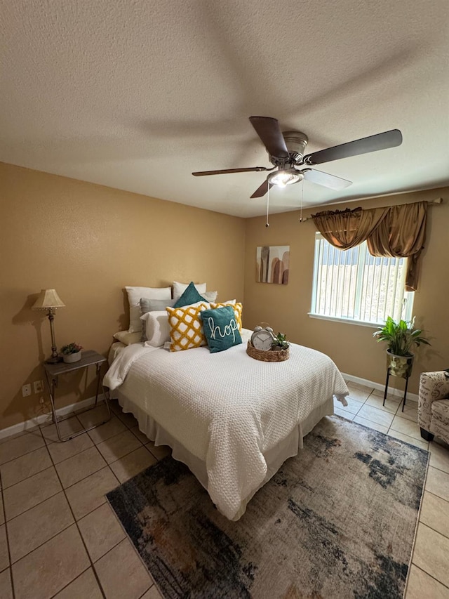 605 W Russell Ave, Visalia, CA 93277 - bedroom with light tile patterned floors, a textured ceiling, and a ceiling fan
