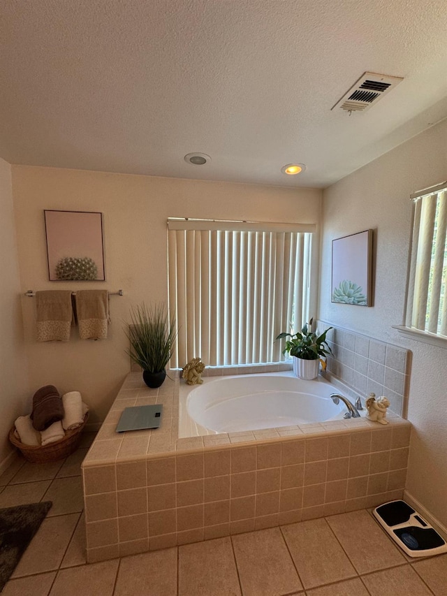 605 W Russell Ave, Visalia, CA 93277 - full bathroom featuring tile patterned floors, a garden tub, and a textured ceiling