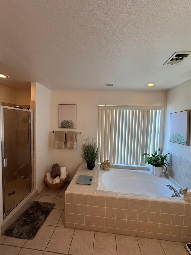 605 W Russell Ave, Visalia, CA 93277 - full bath featuring tile patterned floors, a bath, a stall shower, a textured ceiling, and recessed lighting