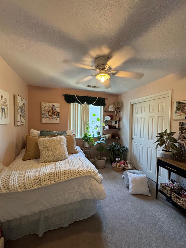 605 W Russell Ave, Visalia, CA 93277 - carpeted bedroom featuring a textured ceiling, a closet, and a ceiling fan