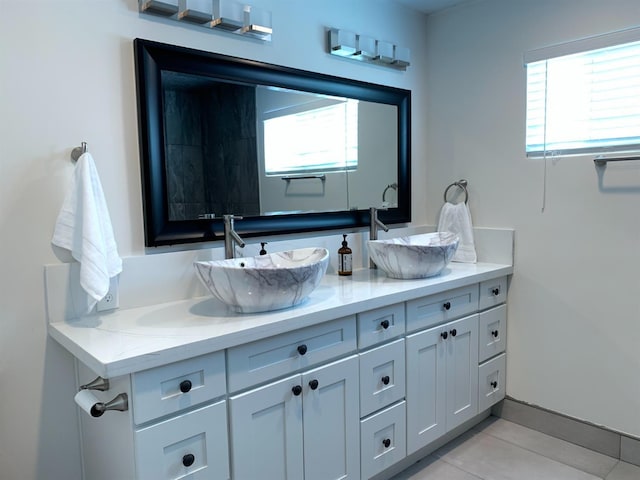 bathroom with plenty of natural light, double vanity, and tile patterned floors