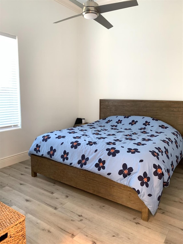 bedroom with light wood-type flooring and a ceiling fan