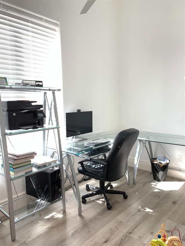 home office with hardwood / wood-style flooring