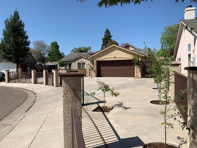 view of front of property featuring driveway, an attached garage, and stucco siding