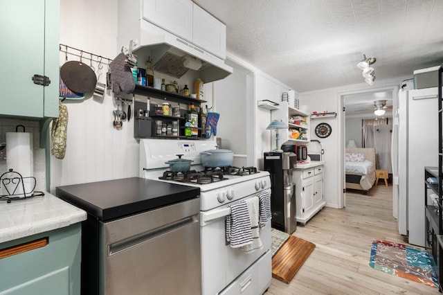 242 Hamlet St, Lemoore, CA 93245 - kitchen with white appliances, under cabinet range hood, light wood-type flooring, open shelves, and ceiling fan