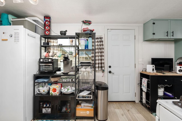 242 Hamlet St, Lemoore, CA 93245 - kitchen featuring freestanding refrigerator, light wood-style flooring, and light countertops