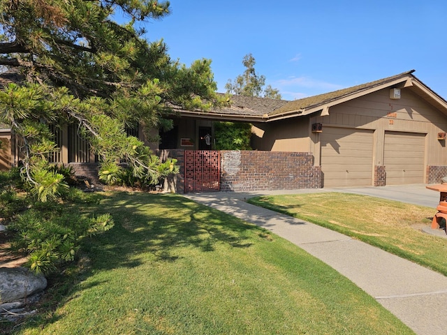 1 Adams Dr, Chowchilla, CA 93610 - view of front of house with driveway, a garage, and brick siding