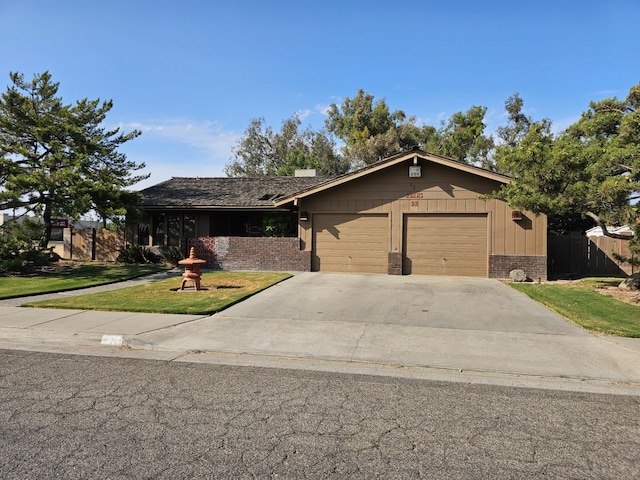 1 Adams Dr, Chowchilla, CA 93610 - view of front of house featuring a garage, brick siding, and concrete driveway