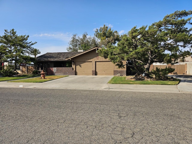 1 Adams Dr, Chowchilla, CA 93610 - view of front facade featuring concrete driveway, an attached garage, and brick siding