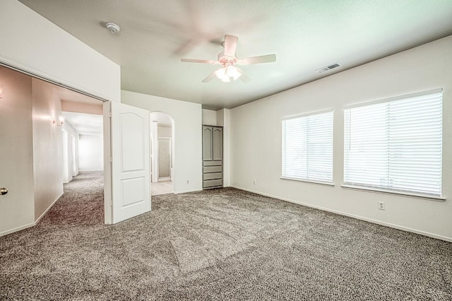 1224 Oak Ave, Clovis, CA 93611 - unfurnished bedroom featuring carpet, arched walkways, and a ceiling fan