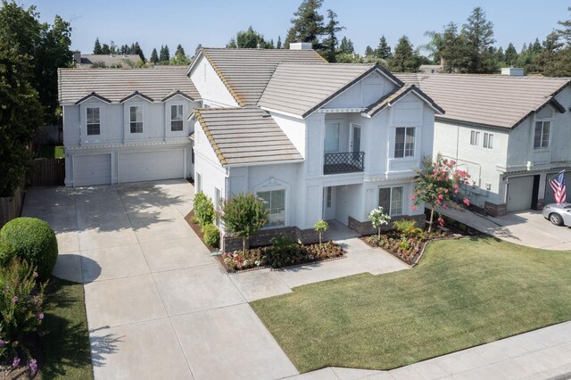 1224 Oak Ave, Clovis, CA 93611 - view of front of home featuring an attached garage, concrete driveway, stucco siding, a tiled roof, and a chimney