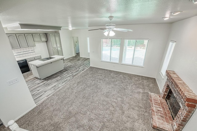 1224 Oak Ave, Clovis, CA 93611 - unfurnished living room featuring a fireplace, a ceiling fan, light wood finished floors, a textured ceiling, and light carpet