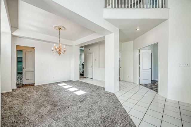 1224 Oak Ave, Clovis, CA 93611 - unfurnished living room with a chandelier, light colored carpet, light tile patterned flooring, stairs, and a raised ceiling