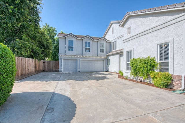 1224 Oak Ave, Clovis, CA 93611 - view of front of house featuring a garage, stucco siding, driveway, and a tiled roof