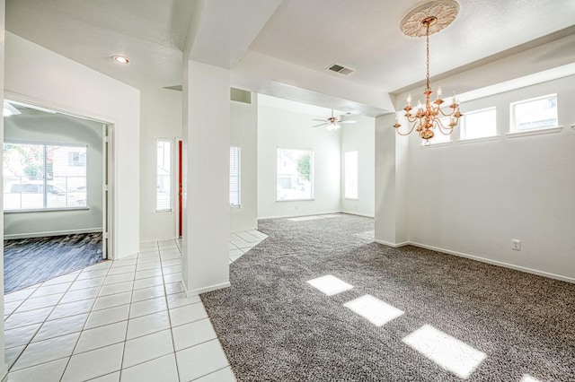 1224 Oak Ave, Clovis, CA 93611 - empty room with a chandelier, ceiling fan, light colored carpet, and light tile patterned floors