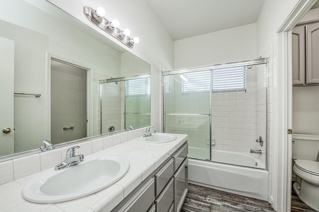 1224 Oak Ave, Clovis, CA 93611 - bathroom featuring wood finished floors, enclosed tub / shower combo, and double vanity