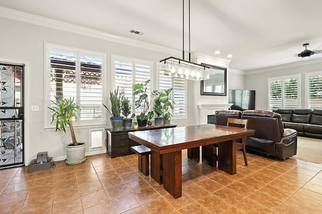 17024 Granite Falls Way, Chowchilla, CA 93610 - dining room featuring crown molding, light tile patterned floors, ceiling fan, recessed lighting, and a fireplace