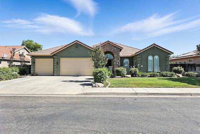17024 Granite Falls Way, Chowchilla, CA 93610 - ranch-style house featuring stucco siding, a garage, a tile roof, driveway, and stone siding