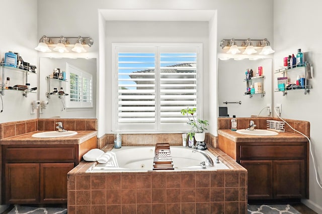 17024 Granite Falls Way, Chowchilla, CA 93610 - full bathroom with plenty of natural light, two vanities, and a tub with jets