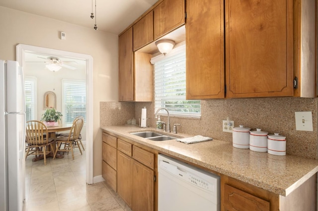 920 W 6th St, Madera, CA 93637 - kitchen with white appliances, ceiling fan, backsplash, and brown cabinetry