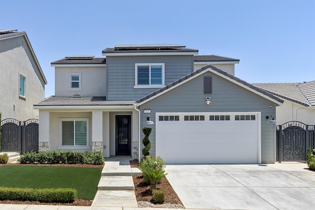 165 Timberline Way S, Madera, CA 93636 - traditional-style house featuring a gate, a garage, concrete driveway, solar panels, and stucco siding