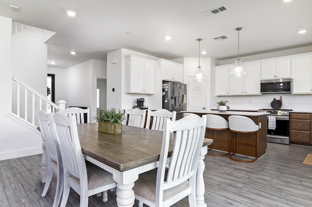 165 Timberline Way S, Madera, CA 93636 - dining space featuring light wood-style floors, stairway, and recessed lighting