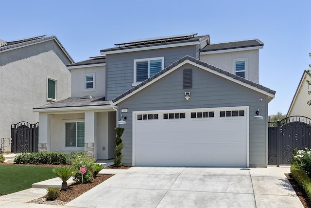 165 Timberline Way S, Madera, CA 93636 - view of front facade featuring a gate, concrete driveway, a garage, stucco siding, and solar panels