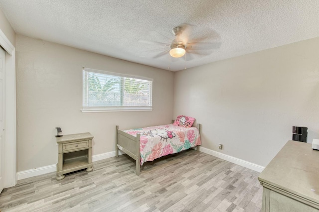 447 W Scott Ave, Clovis, CA 93612 - bedroom featuring light wood finished floors, a textured ceiling, and ceiling fan