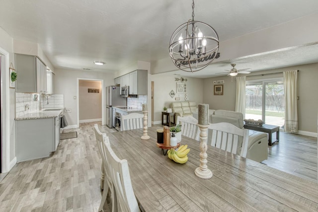 447 W Scott Ave, Clovis, CA 93612 - dining area featuring a chandelier, ceiling fan, and light wood finished floors