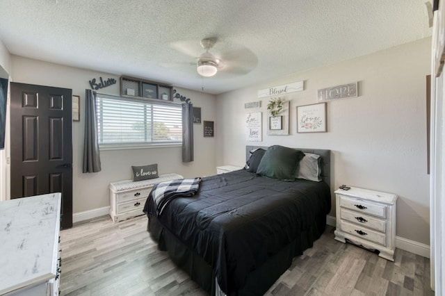 447 W Scott Ave, Clovis, CA 93612 - bedroom featuring light wood-style flooring, a textured ceiling, and a ceiling fan