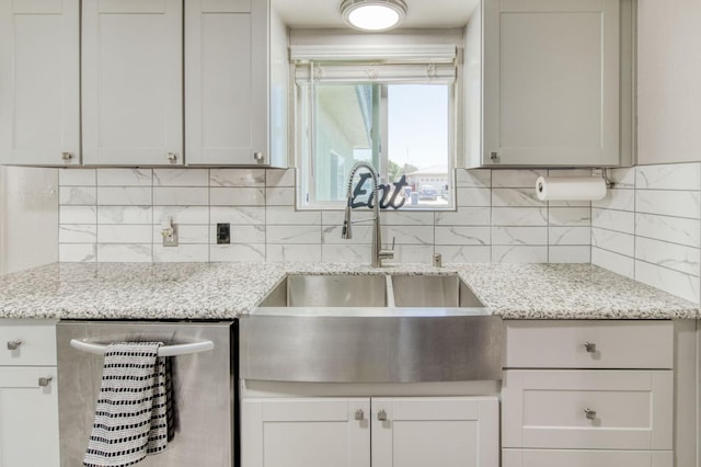 447 W Scott Ave, Clovis, CA 93612 - kitchen with stainless steel dishwasher, decorative backsplash, and light stone counters