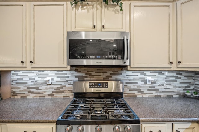 3624 N Jackie, Visalia, CA 93291 - kitchen with appliances with stainless steel finishes, cream cabinetry, tasteful backsplash, and dark countertops
