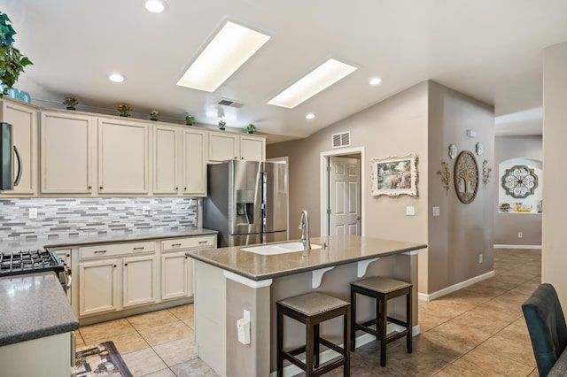 3624 N Jackie, Visalia, CA 93291 - kitchen with stainless steel appliances, decorative backsplash, a skylight, light tile patterned floors, and recessed lighting