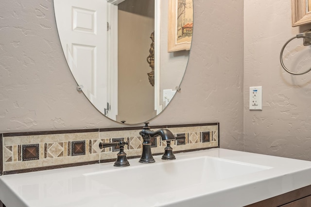 3624 N Jackie, Visalia, CA 93291 - bathroom featuring a textured wall, decorative backsplash, and vanity