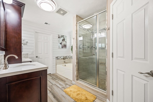 3624 N Jackie, Visalia, CA 93291 - full bathroom with vanity, a garden tub, a stall shower, and wood finished floors