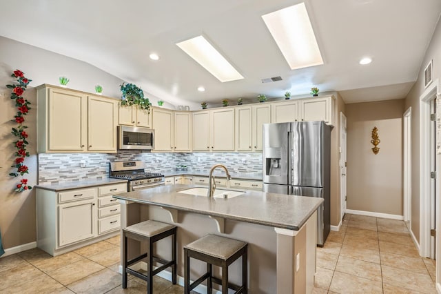 3624 N Jackie, Visalia, CA 93291 - kitchen with stainless steel appliances, backsplash, vaulted ceiling, recessed lighting, and a skylight