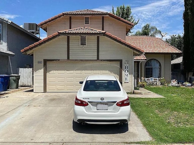 3462 W Wrenwood Ave, Fresno, CA 93711 - view of front of house featuring a tile roof, driveway, an attached garage, and a front lawn