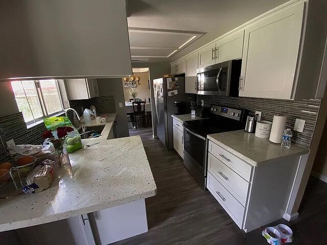 3462 W Wrenwood Ave, Fresno, CA 93711 - kitchen featuring stainless steel appliances, tasteful backsplash, white cabinets, dark wood finished floors, and light stone countertops