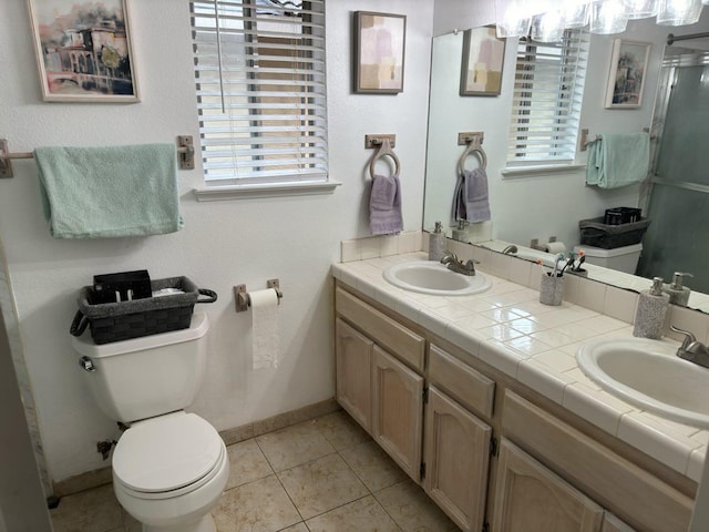 3462 W Wrenwood Ave, Fresno, CA 93711 - full bathroom featuring double vanity, tile patterned flooring, plenty of natural light, and a shower with shower door