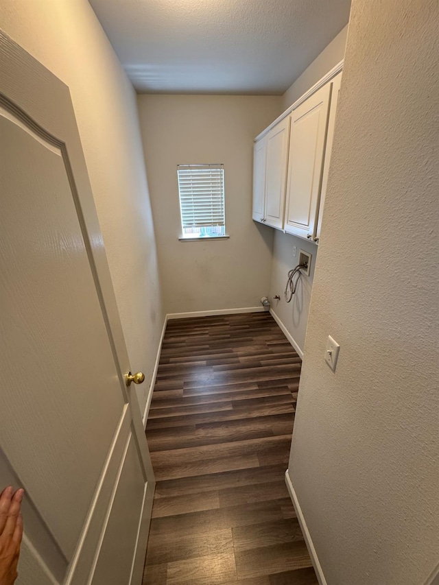 2428 E Emilie Ave, Fresno, CA 93730 - washroom with washer hookup, cabinet space, and dark wood-style flooring