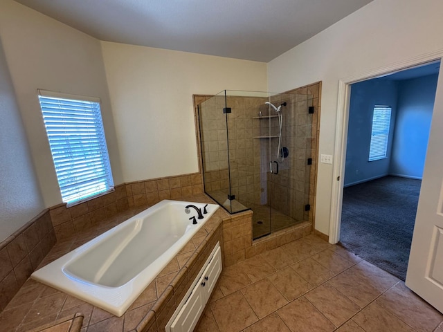 2428 E Emilie Ave, Fresno, CA 93730 - full bathroom featuring plenty of natural light, a garden tub, a shower stall, and tile patterned flooring