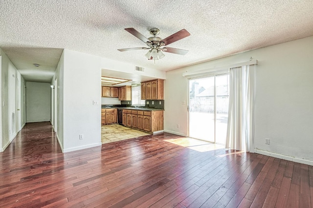 3340 N Dante Ave, Fresno, CA 93722 - unfurnished living room featuring a ceiling fan, wood finished floors, and a textured ceiling