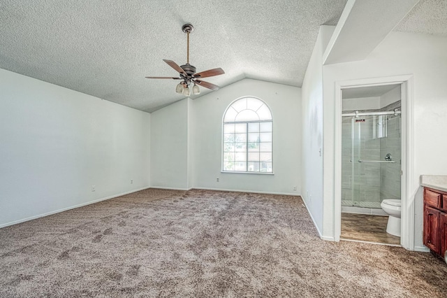 3340 N Dante Ave, Fresno, CA 93722 - unfurnished bedroom featuring carpet flooring, a textured ceiling, lofted ceiling, and connected bathroom