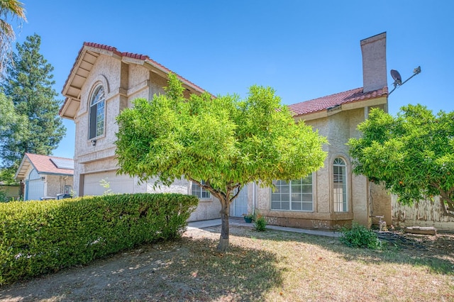 3340 N Dante Ave, Fresno, CA 93722 - view of front of property featuring a tiled roof, an attached garage, and stucco siding