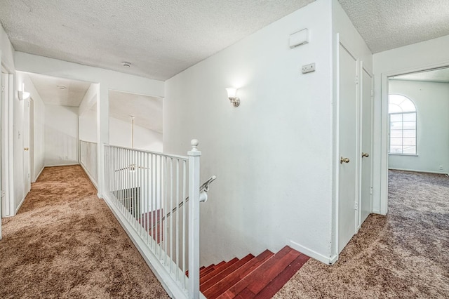 3340 N Dante Ave, Fresno, CA 93722 - hall with carpet floors, a textured ceiling, and an upstairs landing