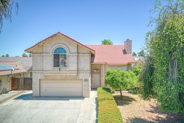 3340 N Dante Ave, Fresno, CA 93722 - mediterranean / spanish home with a chimney, a tile roof, stucco siding, and concrete driveway