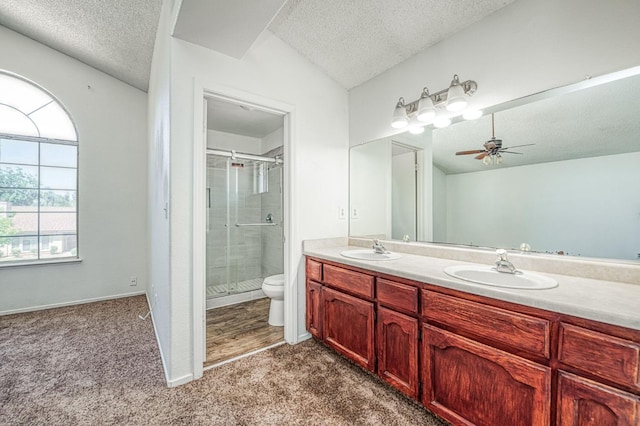 3340 N Dante Ave, Fresno, CA 93722 - full bathroom featuring a textured ceiling, double vanity, a shower stall, and a ceiling fan
