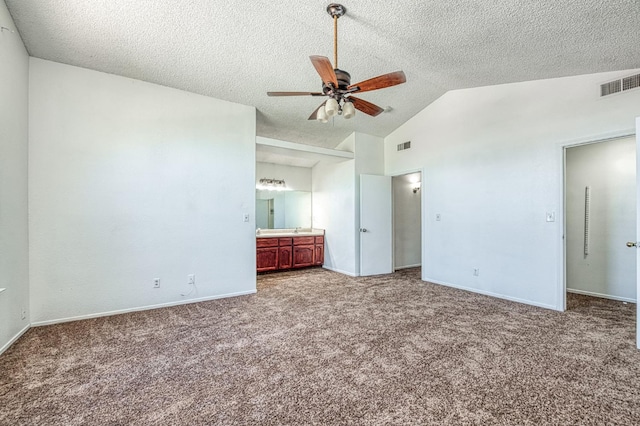 3340 N Dante Ave, Fresno, CA 93722 - unfurnished bedroom with lofted ceiling, carpet floors, a textured ceiling, ensuite bath, and a ceiling fan