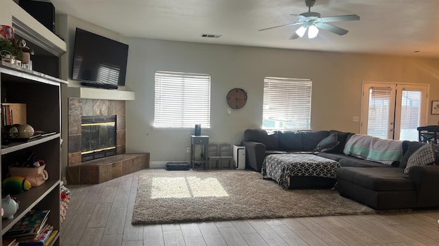 2434 Cherrywood Ct, Hanford, CA 93230 - living area with a ceiling fan, a tile fireplace, and wood finished floors