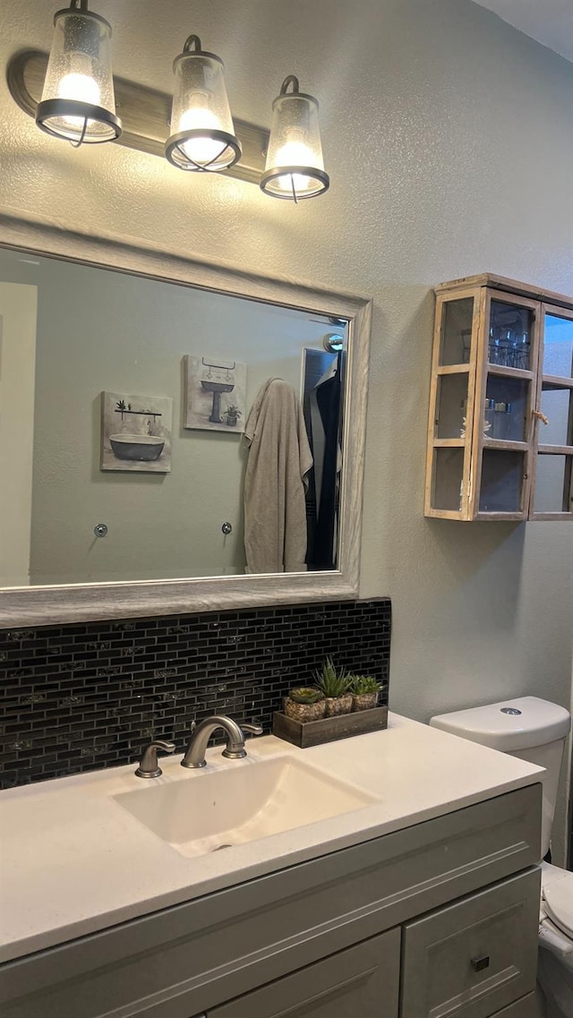 2434 Cherrywood Ct, Hanford, CA 93230 - bathroom featuring vanity and tasteful backsplash